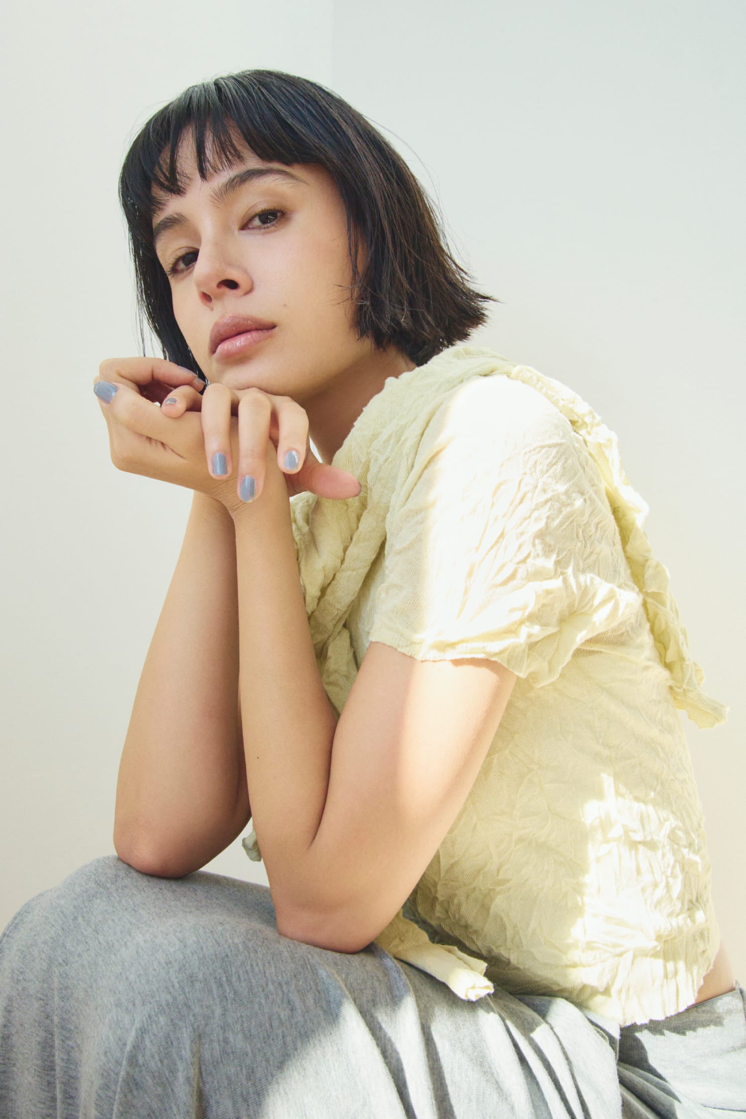 ワッシャーニットＴ&ワッシャーニットシャツ&ニュアンスドレープカットスカート&レザートングストラップサンダルを着用した女性