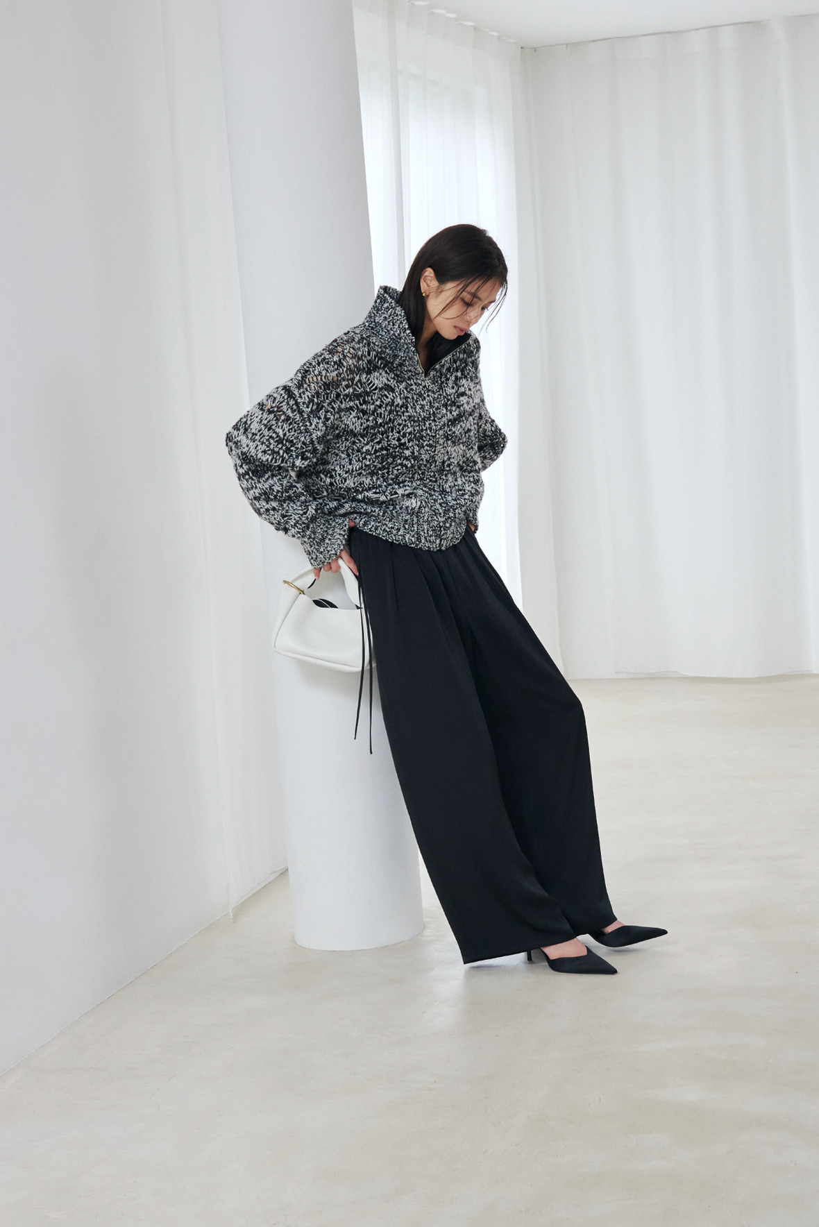 Look10 グレーのニットで柱にもたれる着用カット